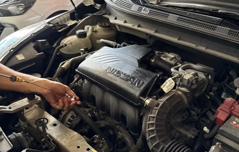 Mecânico conferindo o nível de óleo do motor na Pneu Magno